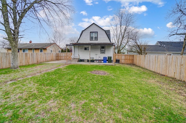 back of house with a patio area and a yard