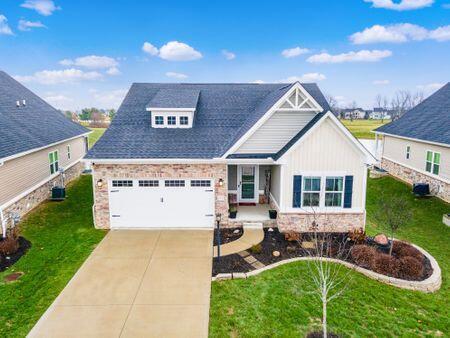 craftsman house with a front yard and a garage