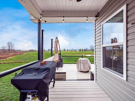 wooden terrace featuring a grill