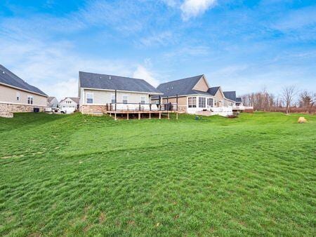 back of house featuring a yard and a deck