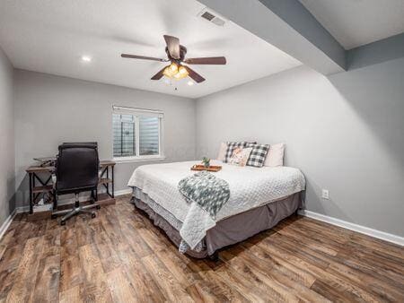 bedroom with hardwood / wood-style floors and ceiling fan