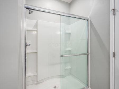 bathroom with a shower with shower door