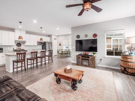 living room featuring hardwood / wood-style floors and ceiling fan