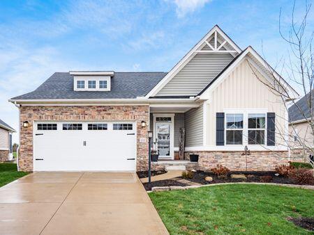 craftsman-style home featuring a front yard and a garage