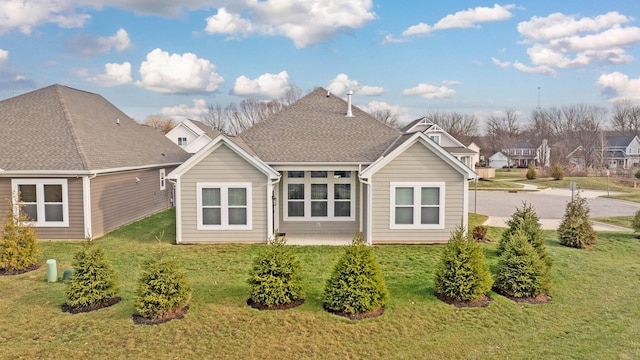 rear view of house with a yard