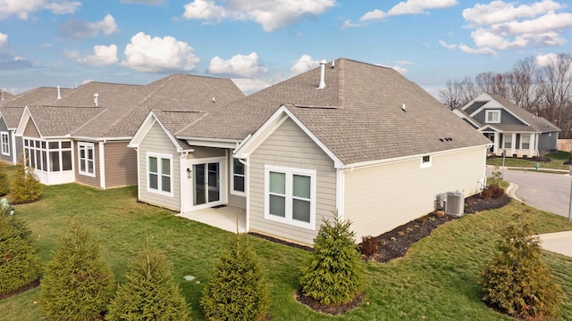 rear view of house with a patio area, a yard, and central AC unit