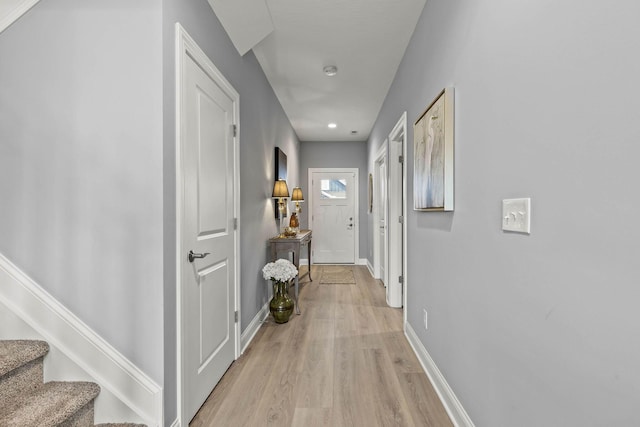 hallway with light hardwood / wood-style flooring