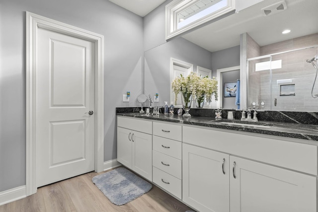 bathroom featuring vanity, hardwood / wood-style flooring, and walk in shower