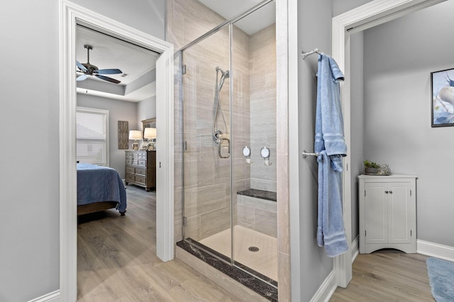 bathroom with ceiling fan, hardwood / wood-style floors, and walk in shower