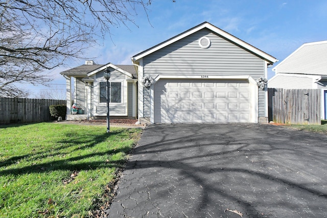 view of front of house with a front yard and a garage