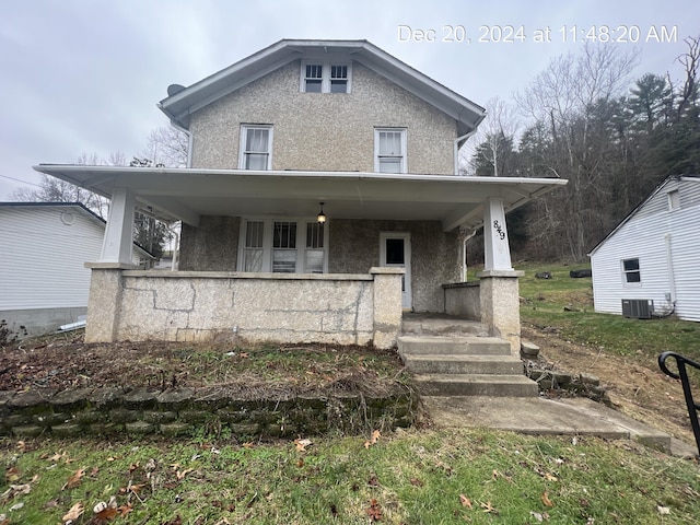 view of front facade with covered porch and cooling unit