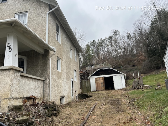 view of home's exterior with a storage shed