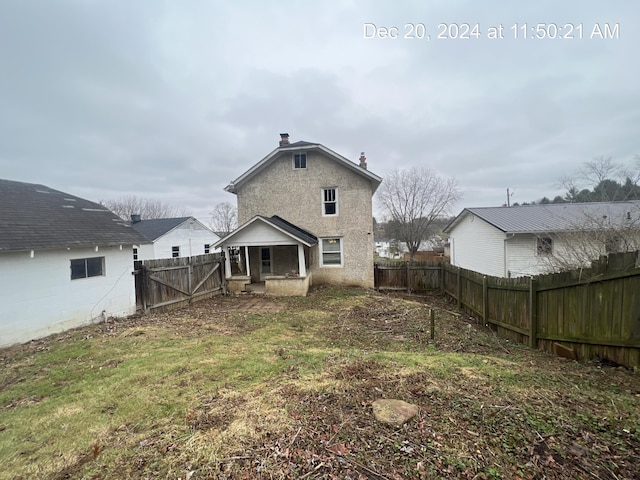 rear view of property with a yard