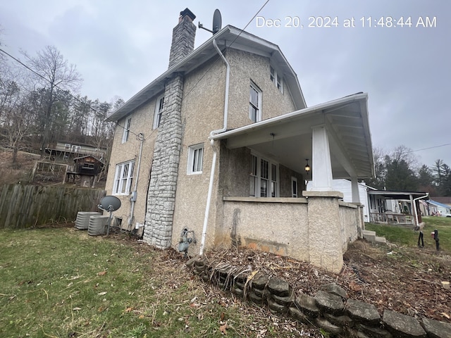 rear view of property with a porch and a yard