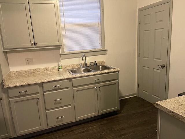 kitchen featuring gray cabinetry, dark wood-type flooring, and sink