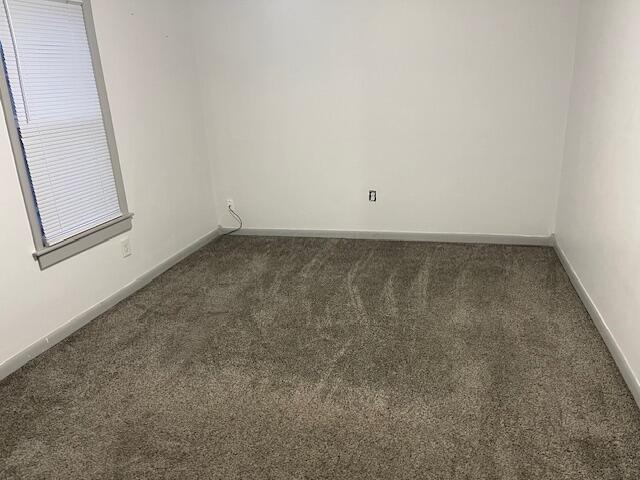 empty room with dark carpet