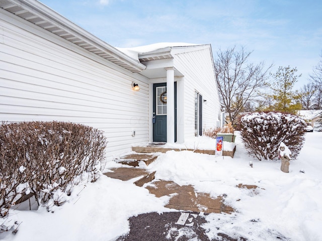 view of snow covered property entrance