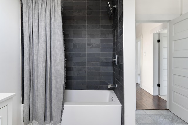 bathroom featuring tile patterned flooring, shower / bath combination with curtain, and vanity