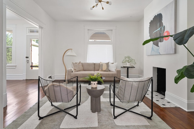 living room featuring hardwood / wood-style floors and an inviting chandelier