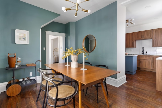 dining area featuring a chandelier, dark hardwood / wood-style flooring, and sink