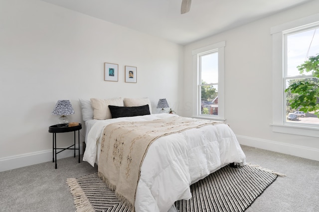 bedroom featuring ceiling fan and light carpet