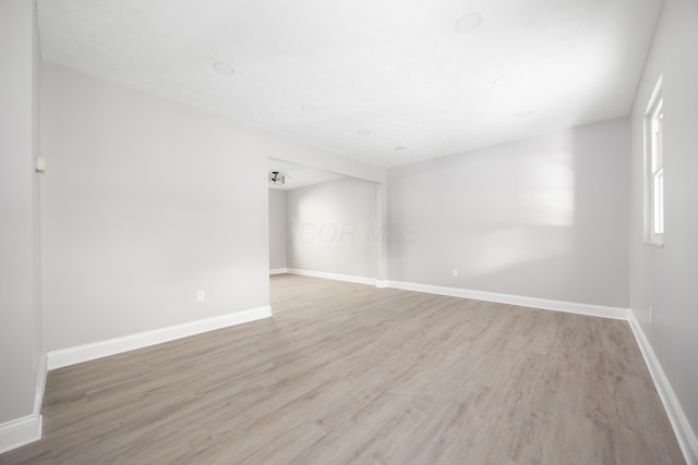 unfurnished room with wood-type flooring