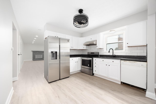 kitchen with white cabinets, light hardwood / wood-style floors, sink, and appliances with stainless steel finishes