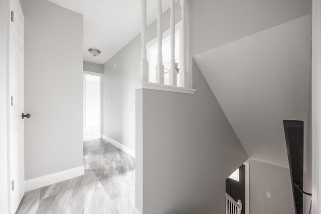 hallway featuring vaulted ceiling