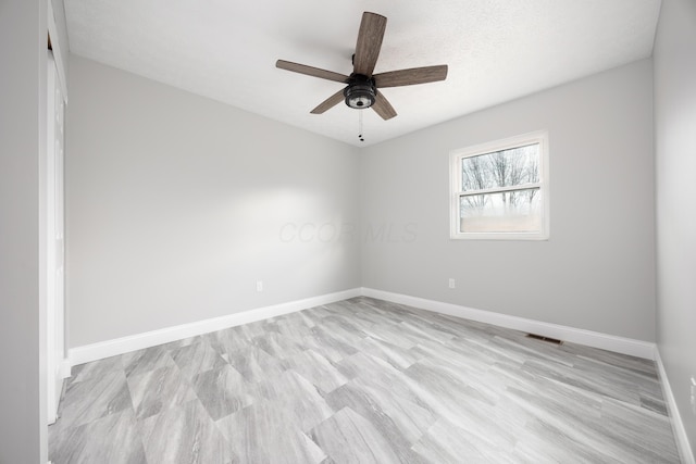 unfurnished room featuring a textured ceiling and ceiling fan