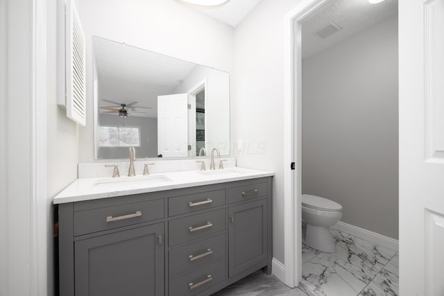 bathroom with ceiling fan, vanity, and toilet