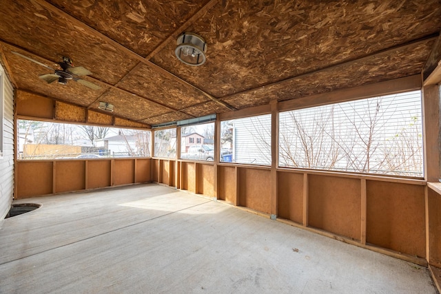 unfurnished sunroom featuring a wealth of natural light and ceiling fan