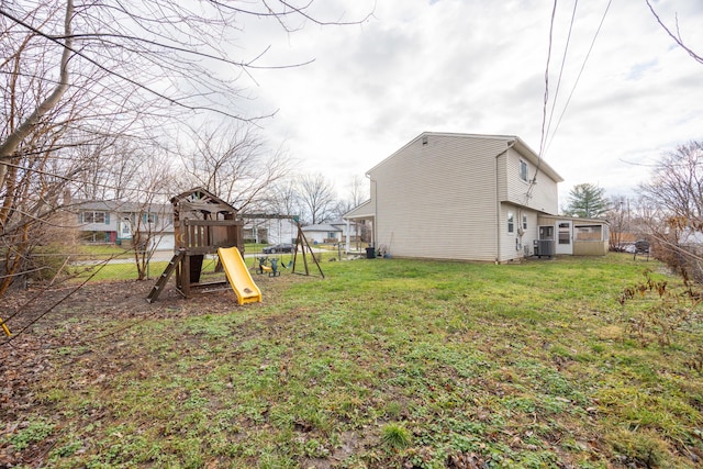 view of yard featuring a playground and central air condition unit