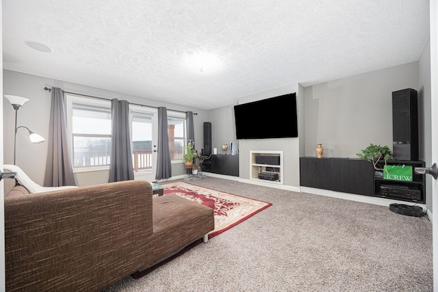 carpeted living room with a fireplace and a textured ceiling