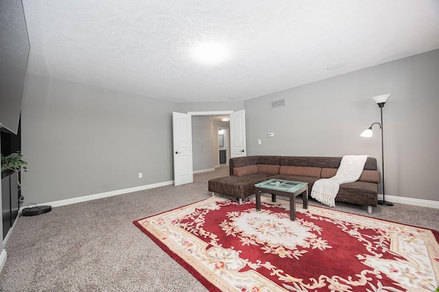 living room with carpet flooring and a textured ceiling