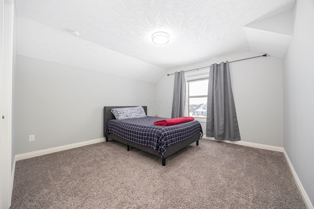 bedroom with carpet flooring, a textured ceiling, and vaulted ceiling