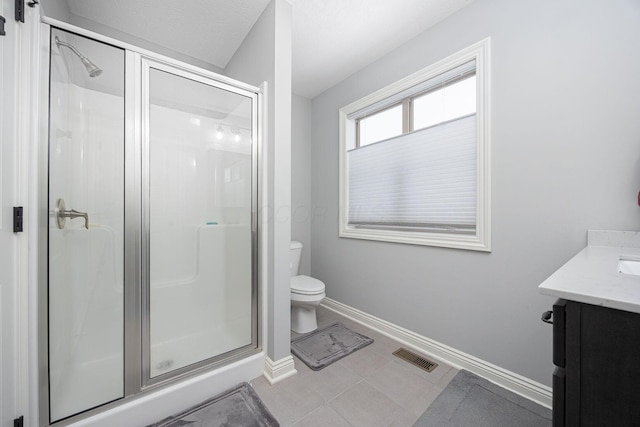 bathroom with vanity, toilet, and a shower with shower door