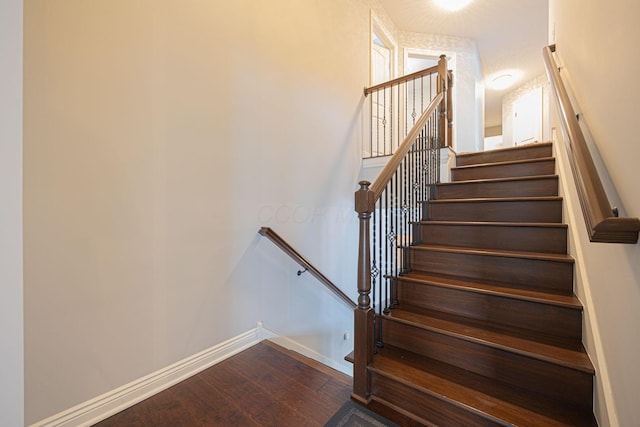 staircase featuring hardwood / wood-style flooring