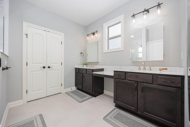 bathroom with tile patterned floors, a shower, and vanity