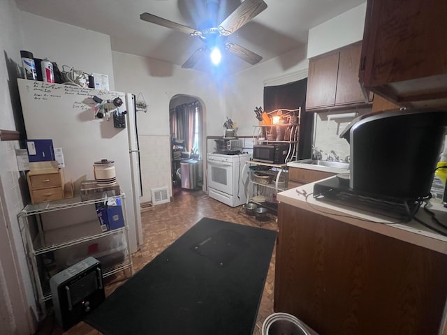 kitchen featuring dark brown cabinetry, ceiling fan, sink, white range, and light parquet floors