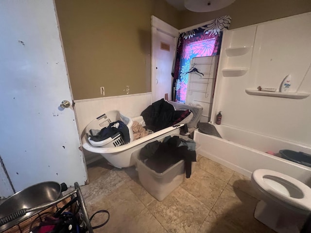 bathroom with tub / shower combination and toilet