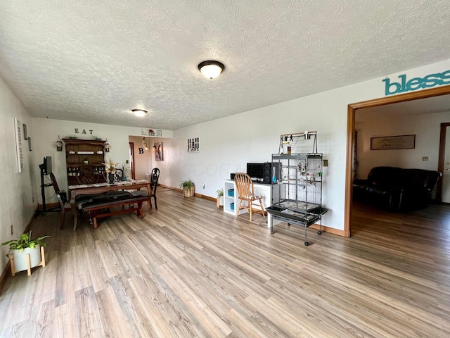 sitting room featuring wood-type flooring and a textured ceiling