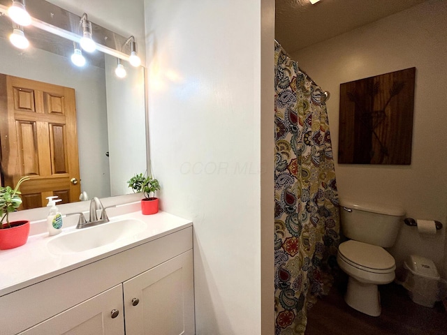 bathroom featuring vanity and toilet