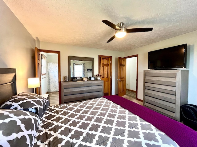 bedroom with ceiling fan and a textured ceiling