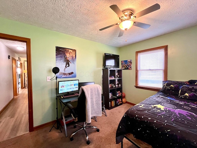 bedroom with a textured ceiling, ceiling fan, and light carpet