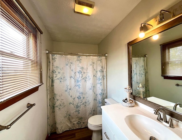 bathroom with vanity, hardwood / wood-style floors, a textured ceiling, and toilet