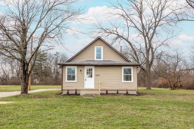 bungalow-style home with a front lawn