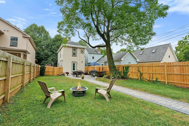 view of yard featuring a patio area and an outdoor fire pit