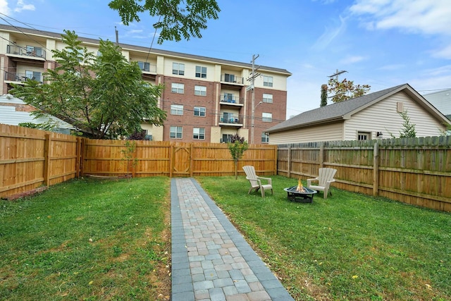 view of yard with an outdoor fire pit