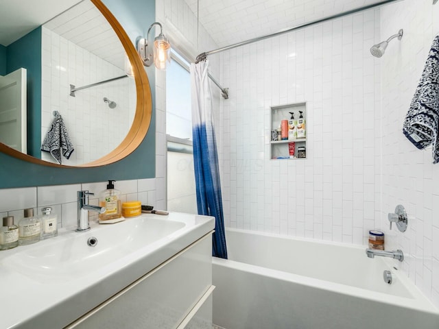 bathroom featuring shower / bath combo with shower curtain and sink