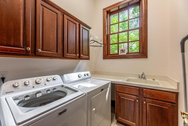 laundry room with washer and dryer, cabinets, and sink